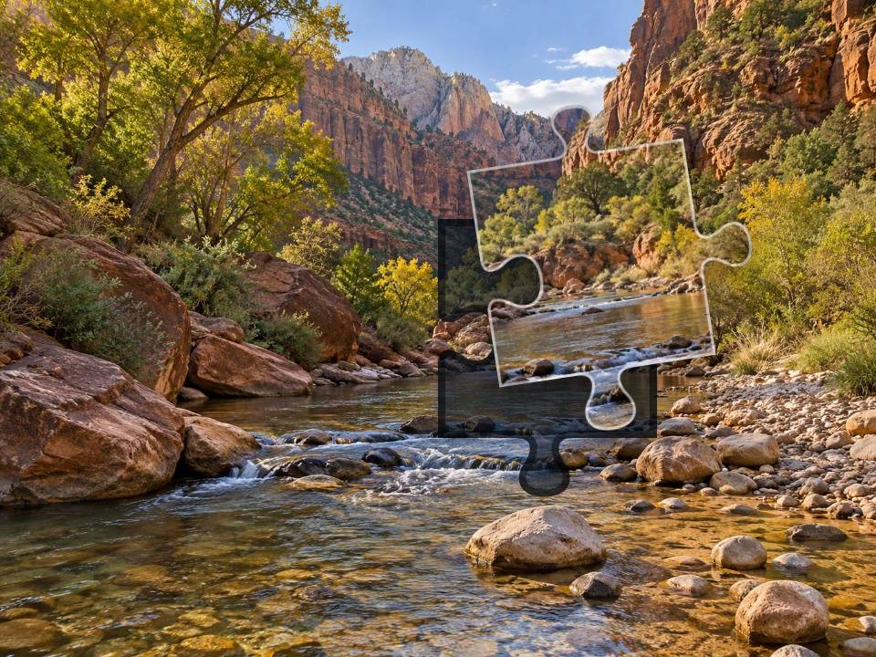 Clear shallow creek winding through red sandstone, pale pebbles, sagebrush and cottonwood trees.